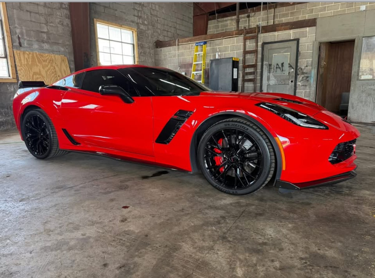 A red Corvette Z06 with tinted windows in The Wrap Houz bay