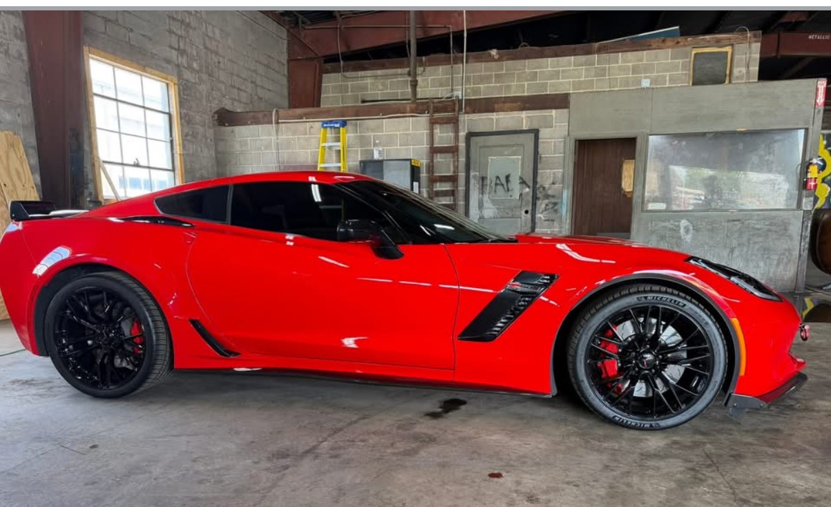 Red Corvette Z06 side profile with dark tint