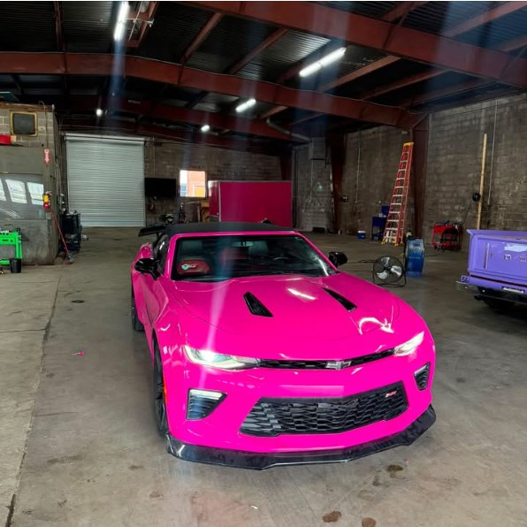 Pink Camaro SS convertible in the shop