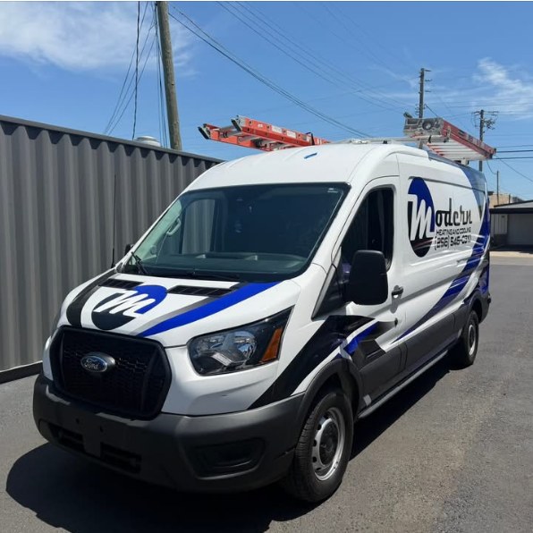 Modern Heating and Cooling van with a blue and black commercial wrap